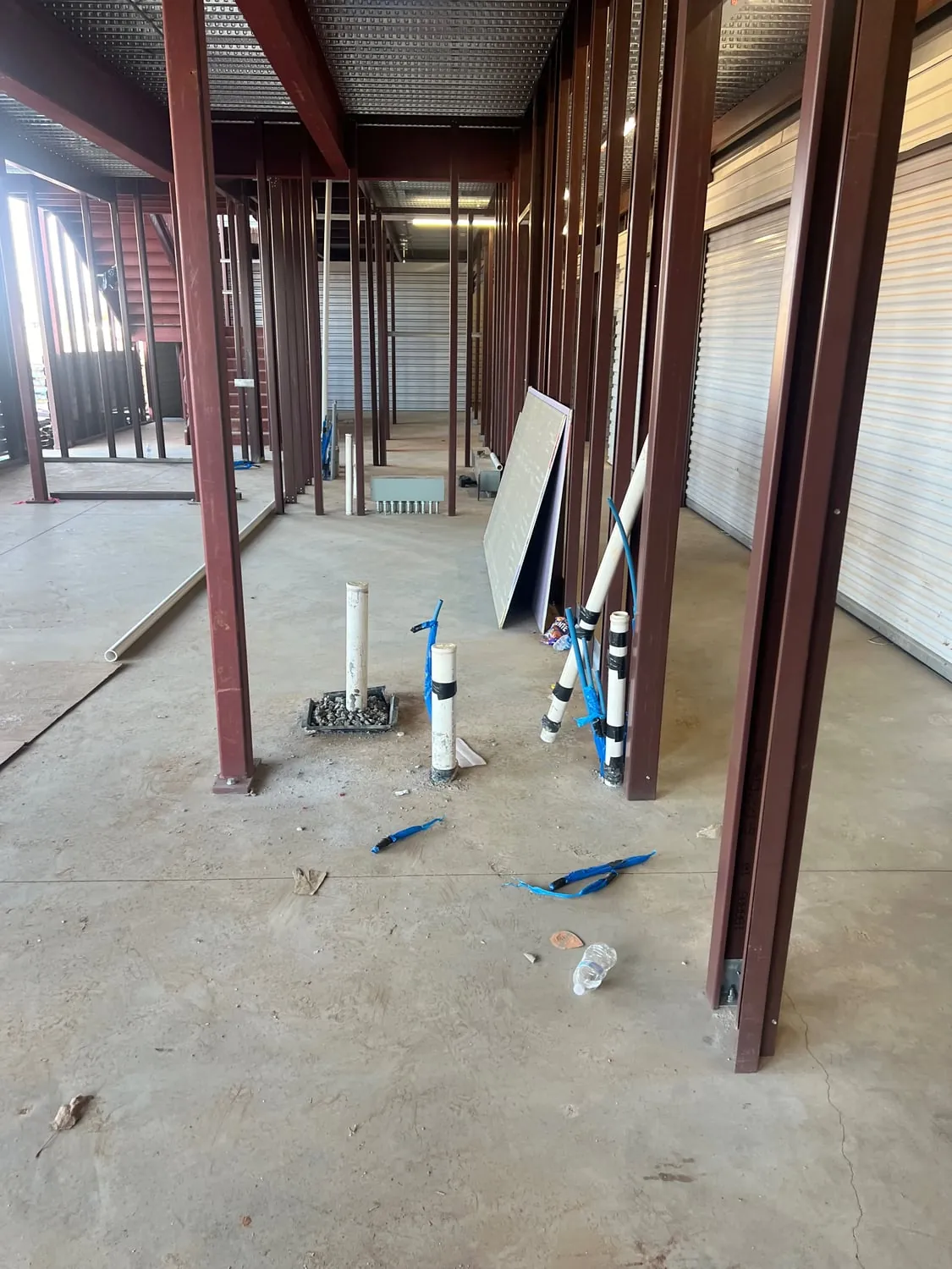 Rough-in stub-ups on a concrete floor between steel columns