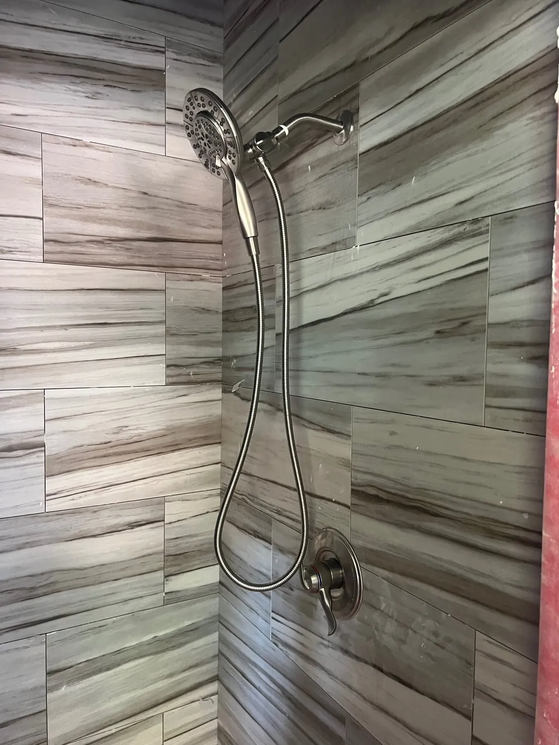 Shower head and handheld combination on wood-look tile